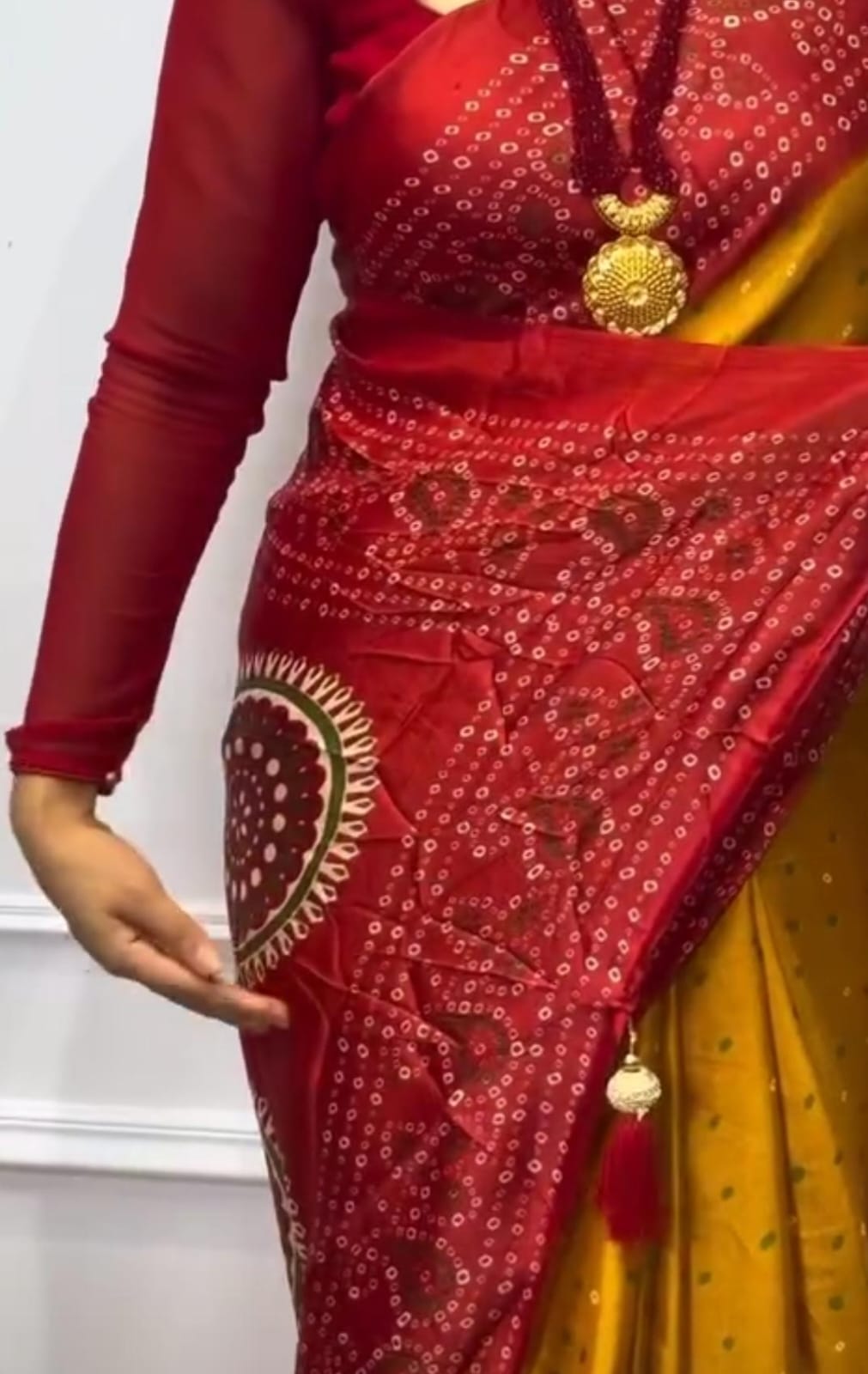 Mustard and red bandhani saree.